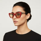 Red cat-eye sunglasses with black frames on a white background